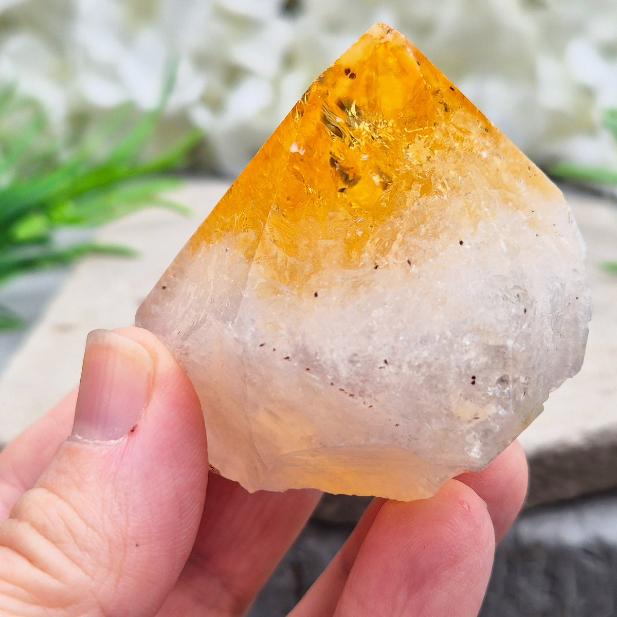 Citrine crystal standing point from Brazil with a polished tip and natural sides. Associated with confidence, motivation, positivity, and personal growth.
