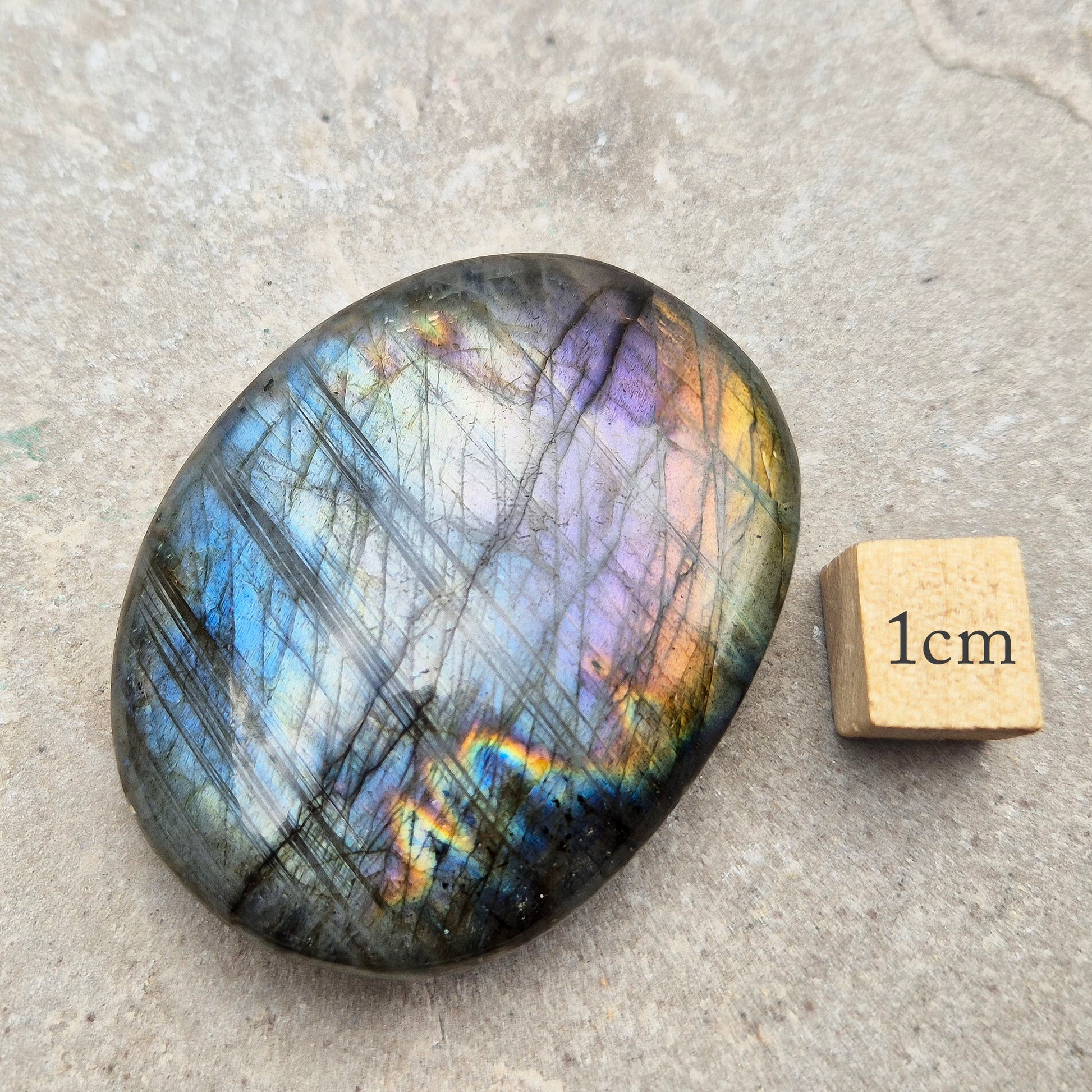 Mystical Labradorite palm stone from Madagascar with vibrant flash. Supports intuition, aura protection & energy clearing. Pocket-sized crystal.