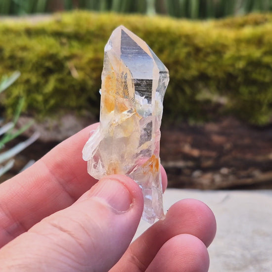 This rare Blade of Light Quartz is a striking Lemurian Quartz from the mountains of Colombia. Known for its exceptional clarity and natural brilliance, this piece features a point that has a few smaller crystals growing out of/into it. 