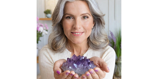 elysian crystals woman holding an amethyst cluster