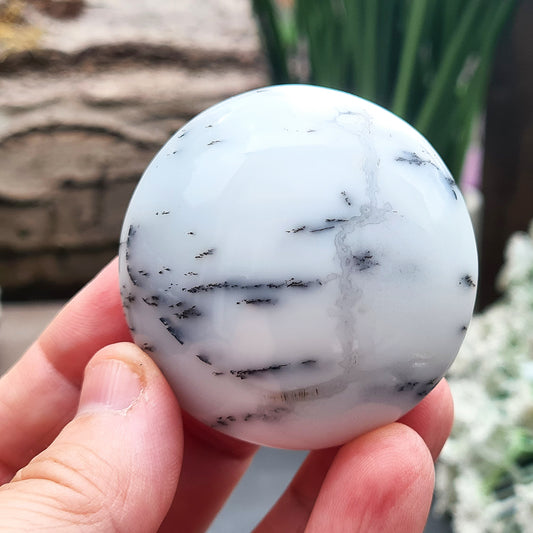 Merlinite Galet from Madagascar. Fabulous, off white, grey and Lavender colouring. These Merlinite Galets are made up of White Opal and dendritic (fern like) inclusions of a black mineral called Psilomelane ( a black manganese oxide). Its a fabulous crystal. Circular in shape.