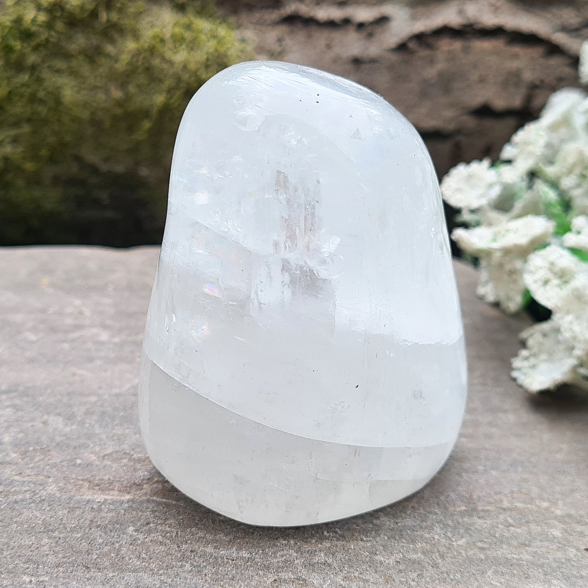 Calcite Freeform, White Calcite Freeform. In the light this crystal is very sparkly and a lot of light reflection. There are rainbows within this crystal.
