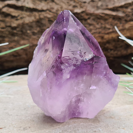 amethyst standing point with bubble like inclusions, deep purple.